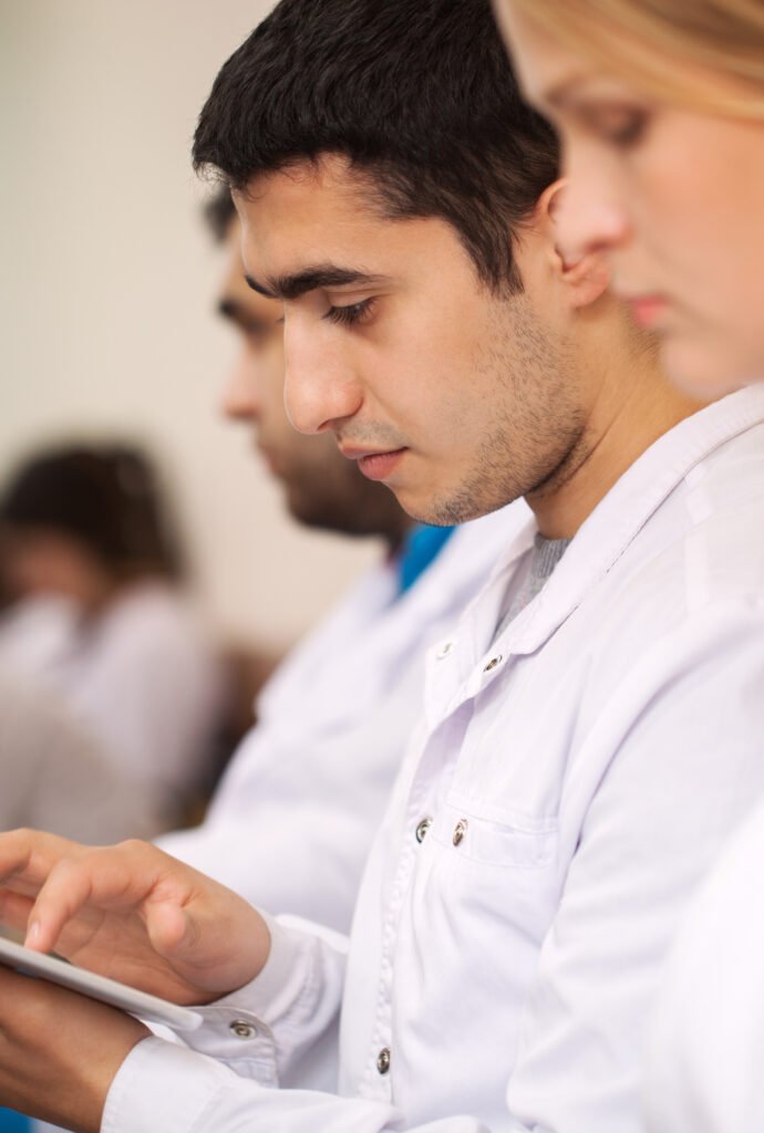 Medical student working with pad on the conference